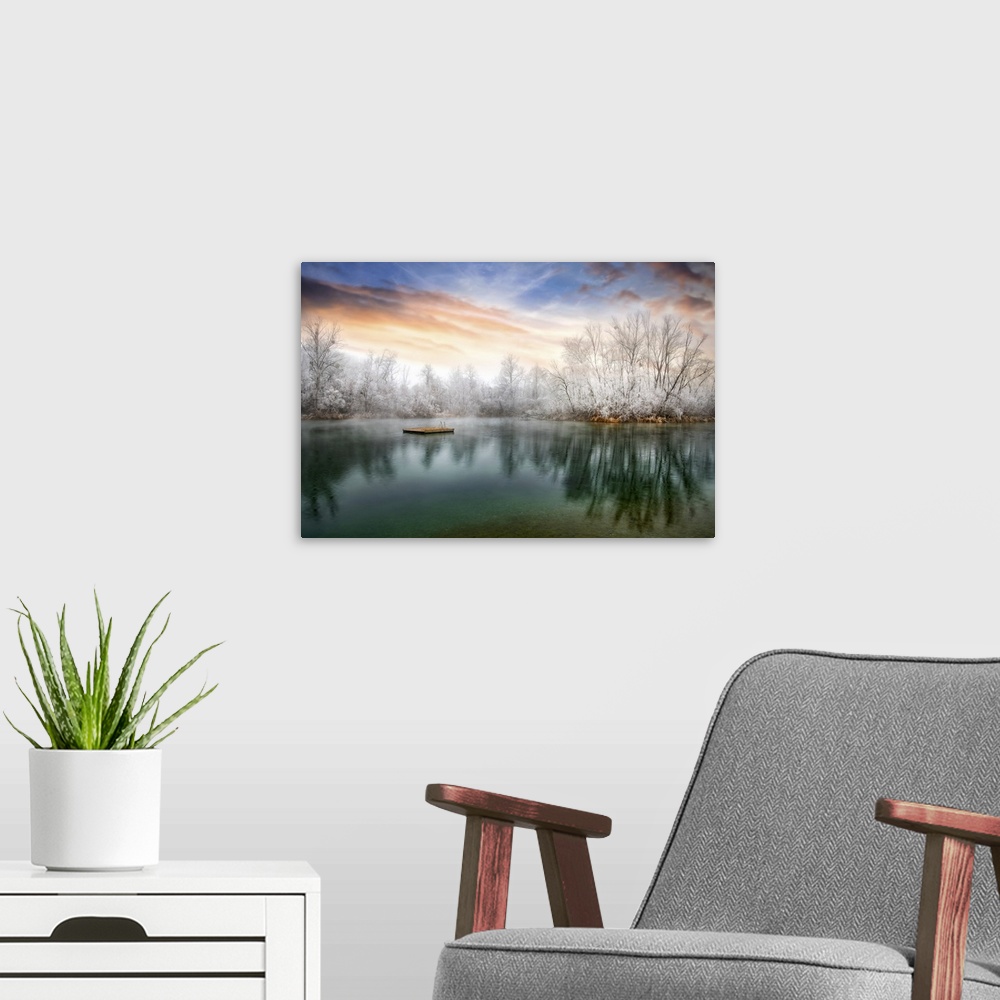 A modern room featuring Photograph of a cold sunset across from a lake lined with frozen trees.