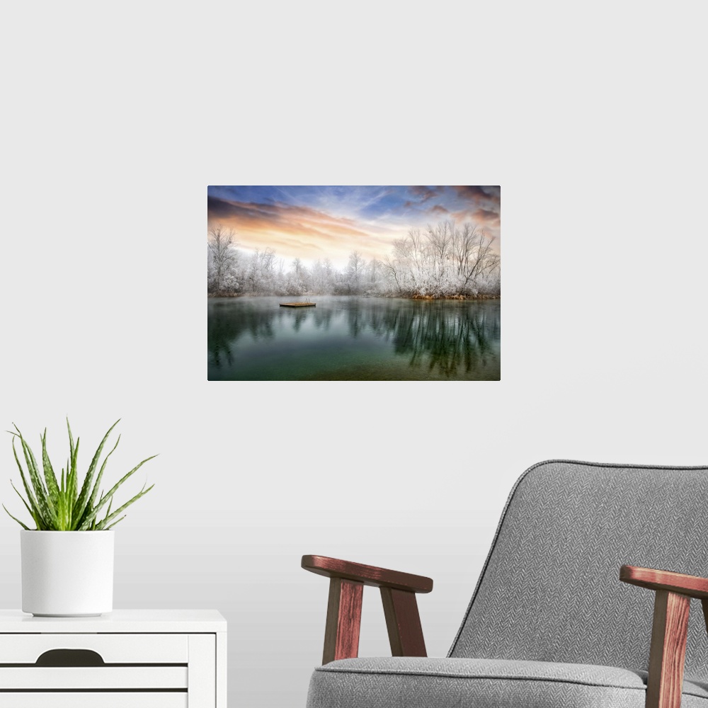 A modern room featuring Photograph of a cold sunset across from a lake lined with frozen trees.