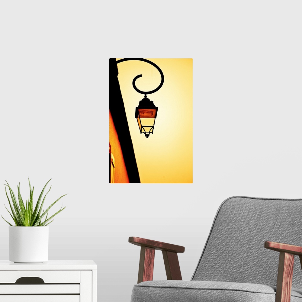A modern room featuring A glowing golden yellow sky with a vintage wrought iron gas lamp.