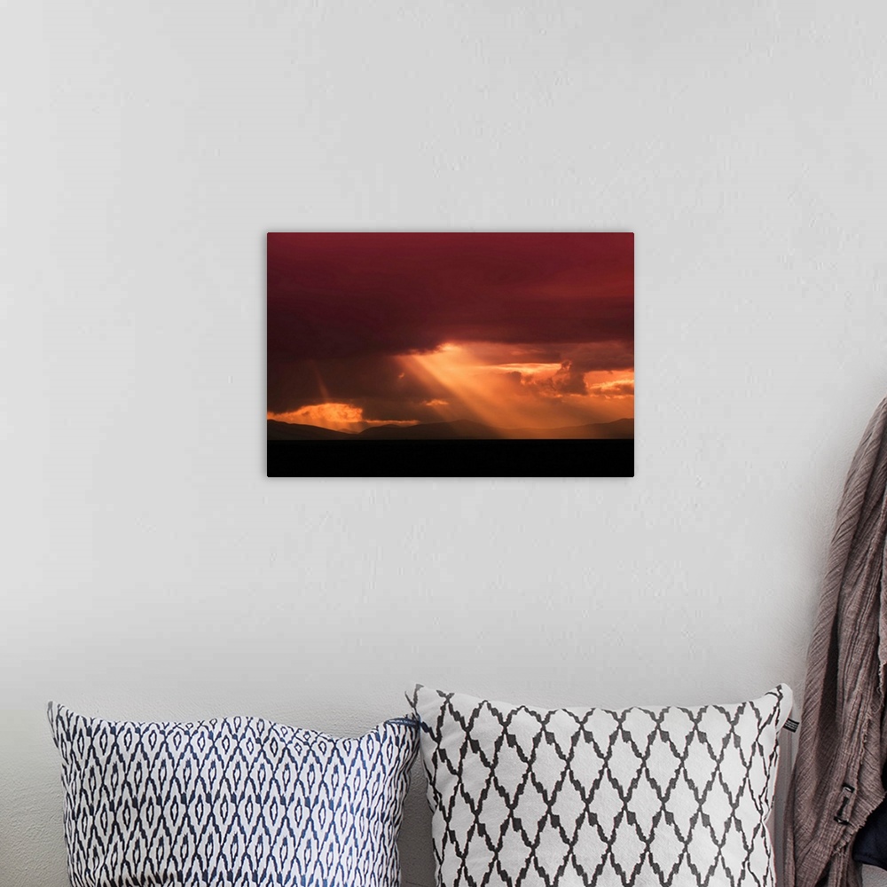 A bohemian room featuring Fine art photo of a bright beam of light shining through the clouds at sunset.