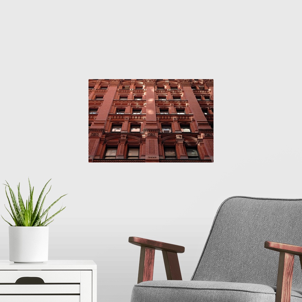 A modern room featuring Looking up at the detailed architecture of a building with lots of brickwork, inset columns, and ...