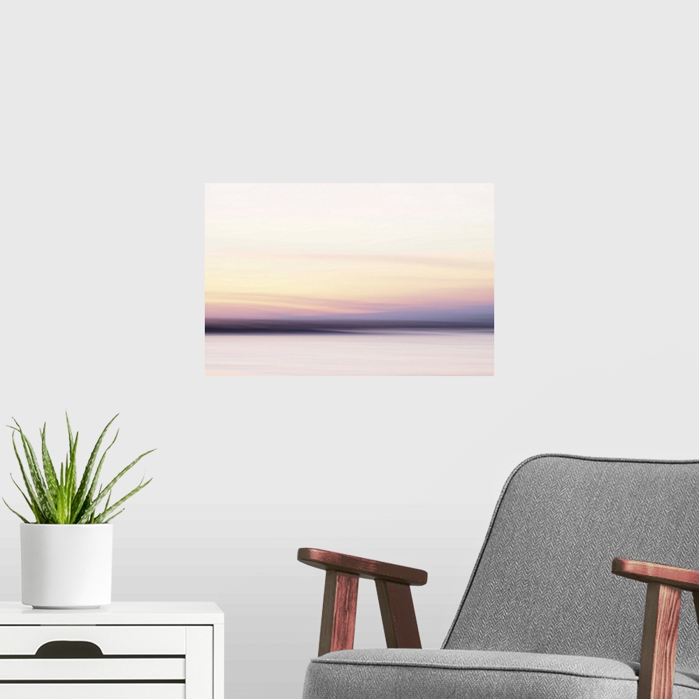 A modern room featuring Artistically blurred photo. A sunset like a fairy tale. The clouds drag the sun to the horizon.
