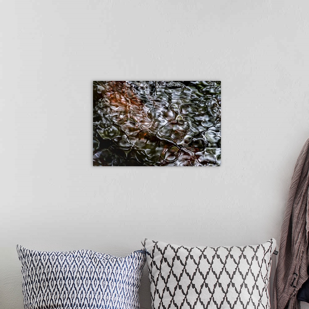 A bohemian room featuring A photograph of a close-up of rippled water with a dark brown peering through the surface.
