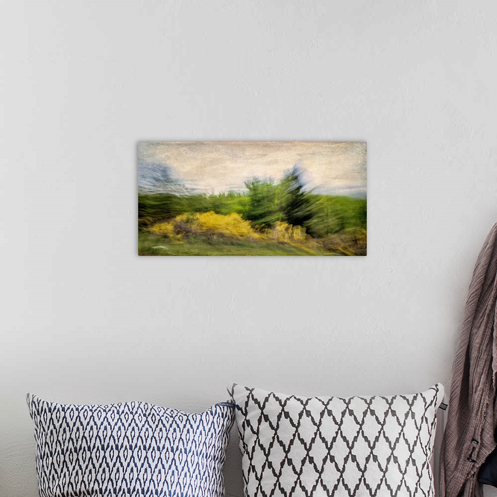 A bohemian room featuring A turbulent scene of the wind stirring up the trees and clouds.