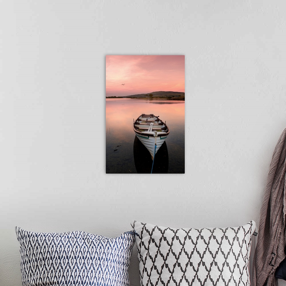A bohemian room featuring A fishing boat on a lake in Ireland at sunset