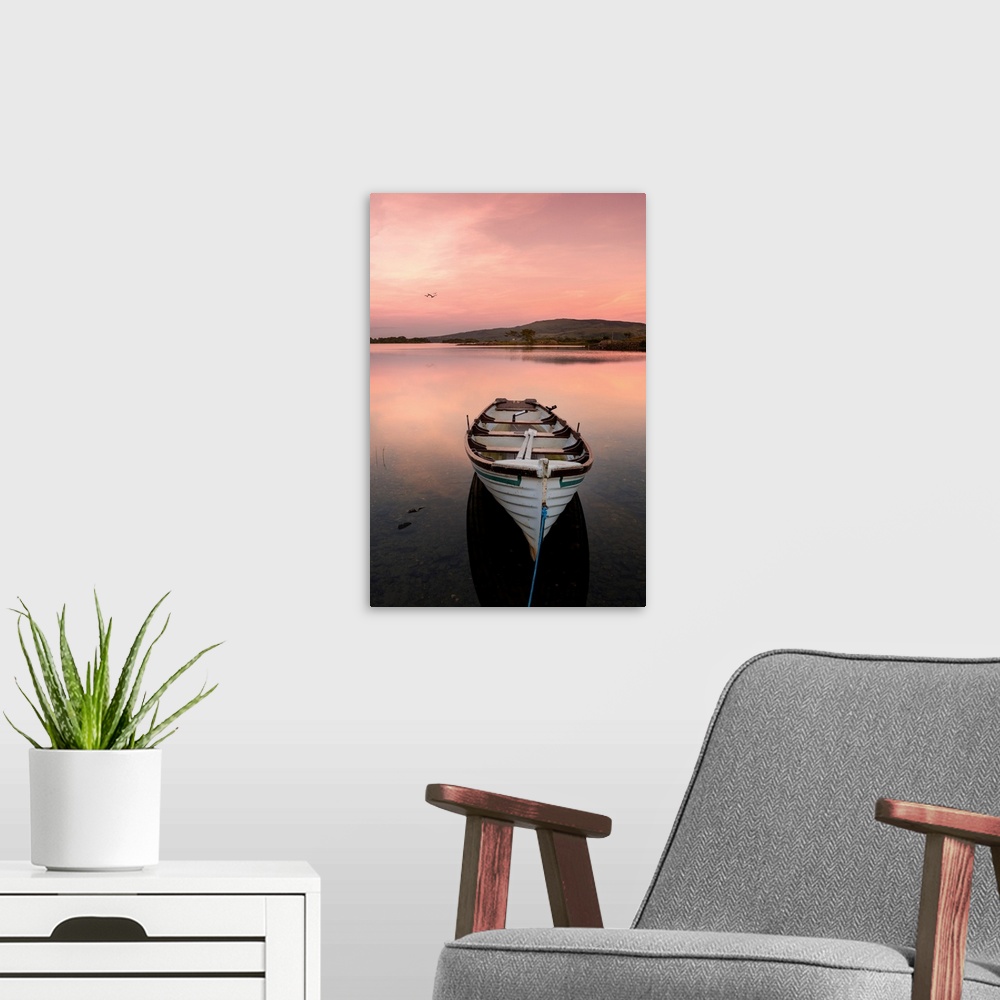 A modern room featuring A fishing boat on a lake in Ireland at sunset