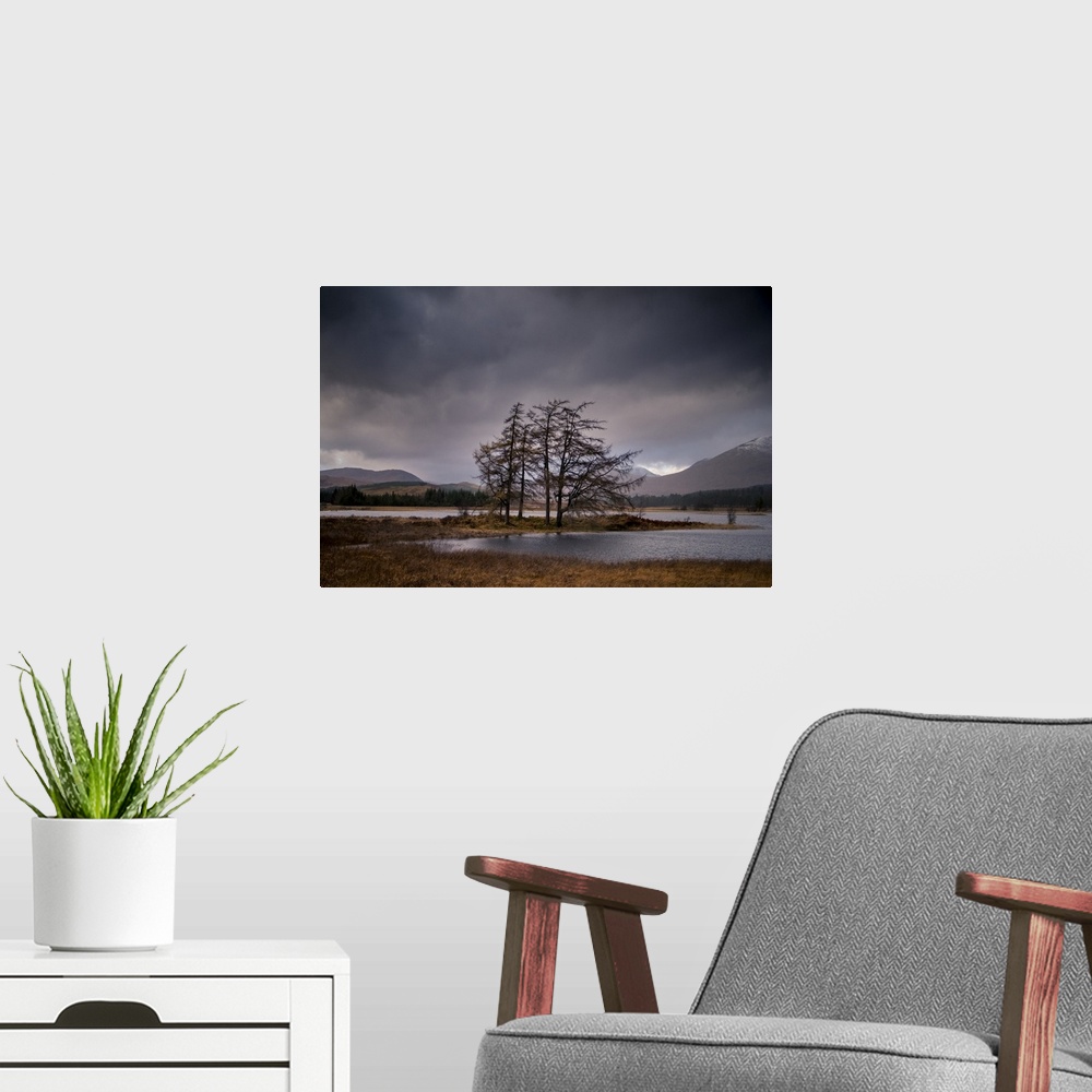 A modern room featuring Landscape photograph of Loch Tulla in Scotland with mountains in the background and an overcast sky.