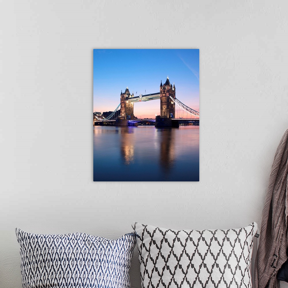 A bohemian room featuring Tower Bridge, London, UK at sunrise with a clear blue sky and reflections in the River Thames.