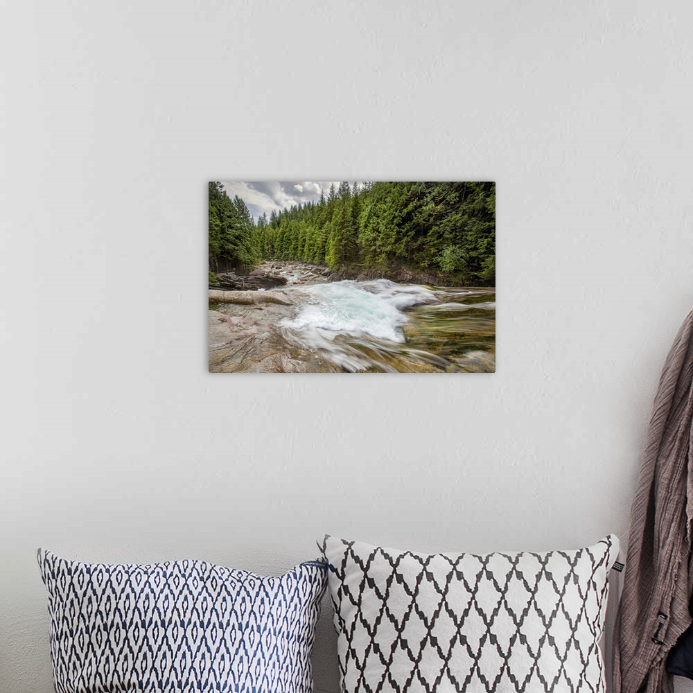 A bohemian room featuring A long exposure of a rushing river through a forest.