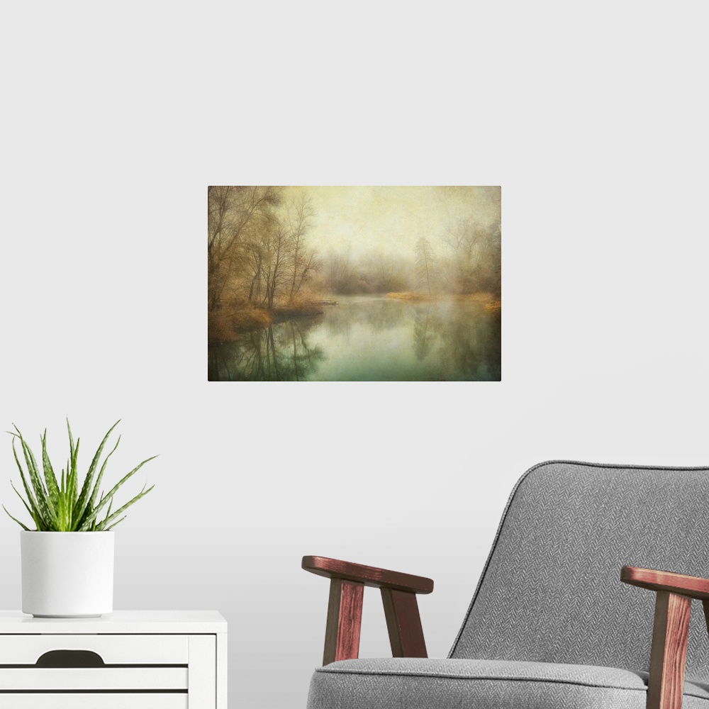 A modern room featuring Antique style photograph of winter trees lining a calm body of water.