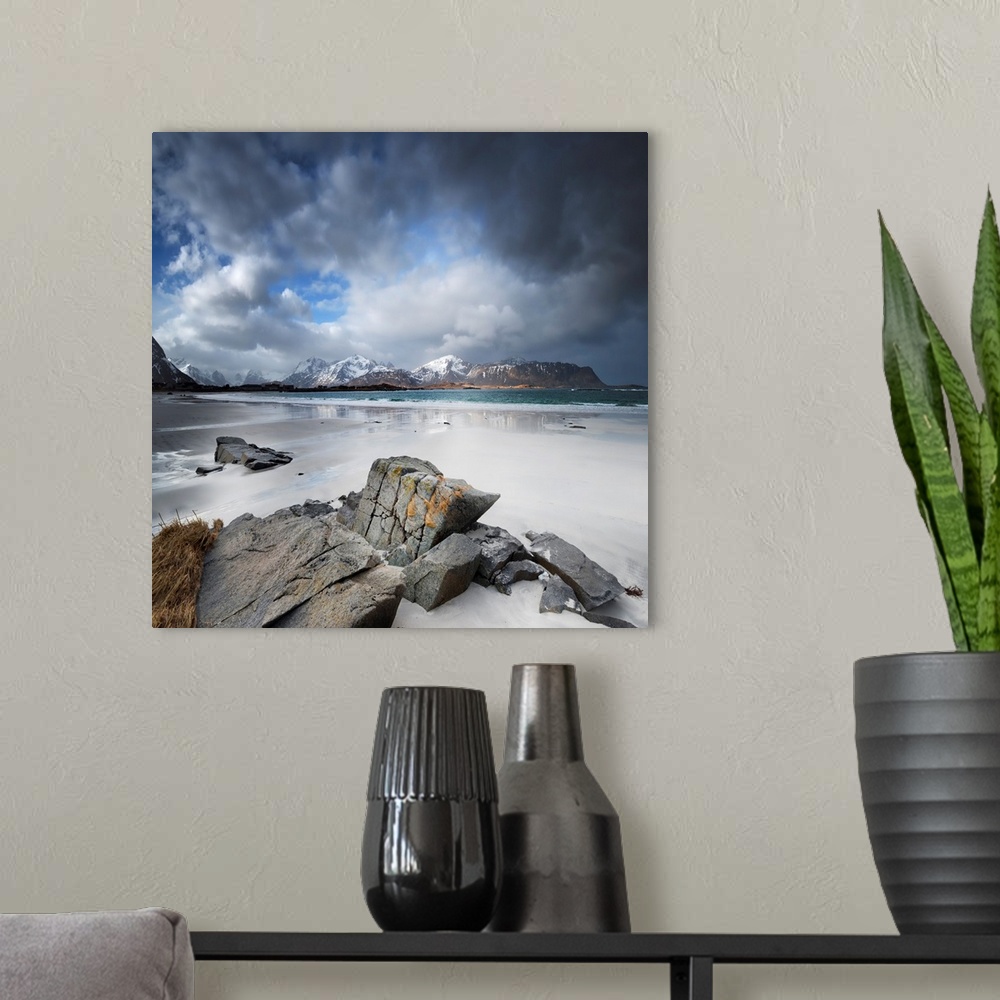 A modern room featuring View of mountains from a long beach casting reflections in the tide.