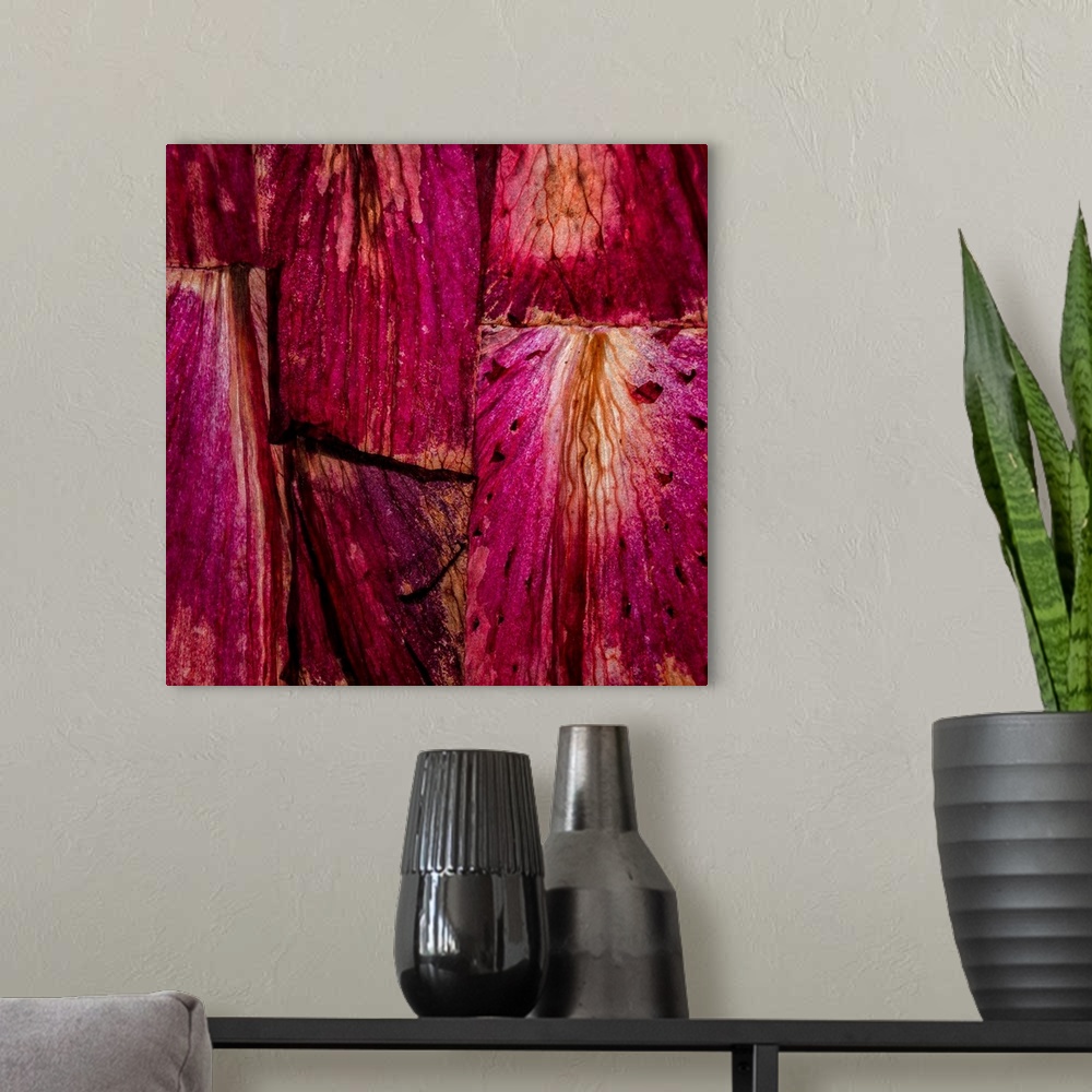 A modern room featuring Square abstract art with sections of wood placed together in bright shades of pink and purple.