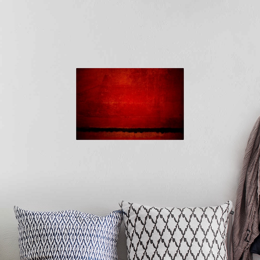 A bohemian room featuring Abstract artwork of a red tones and a black horizon line with a distressed texture throughout.