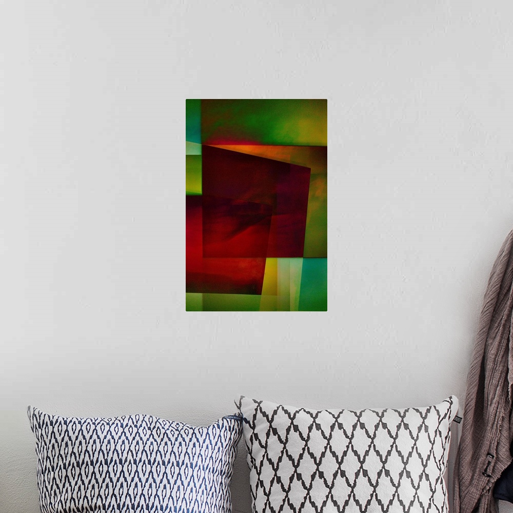 A bohemian room featuring Geometric abstract artwork that consists of deep reds and shades of green in polygonal shapes.