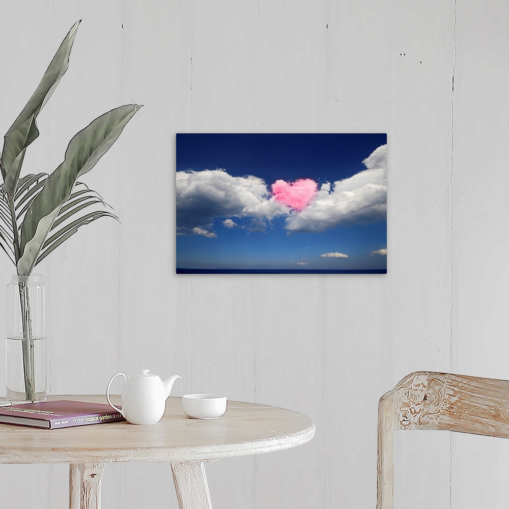 A farmhouse room featuring This large piece shows immense clouds with a heart shaped cloud in the middle that has been color...