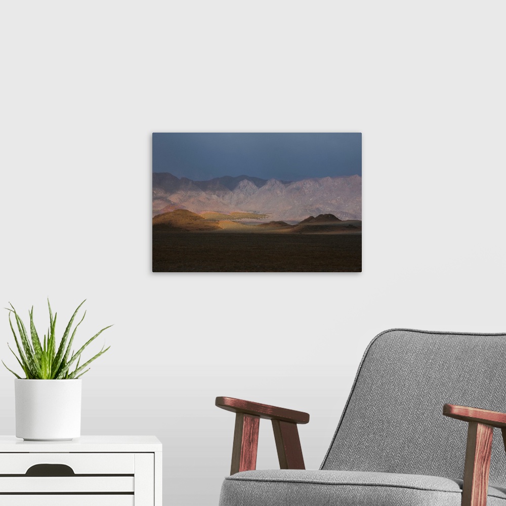 A modern room featuring Composited landscape image with rolling hills and mountains.