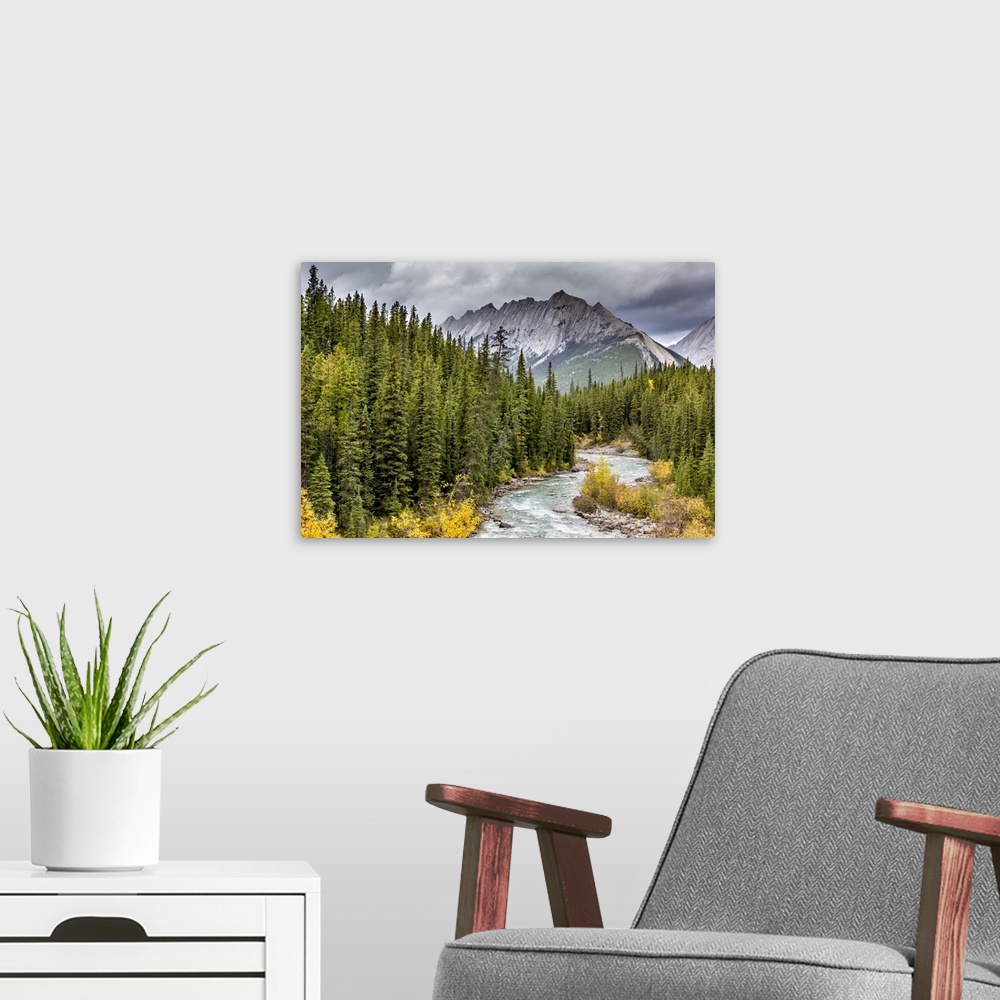 A modern room featuring A delightful scene of Maligne River leading towards Grisette Mtn in Jasper, Alberta.