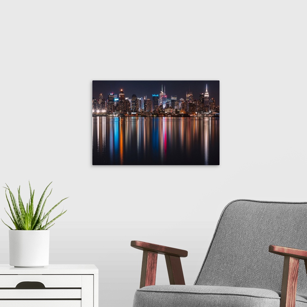 A modern room featuring Long exposure of Manhattan, NYC and its rainbow reflection in the Hudson River.