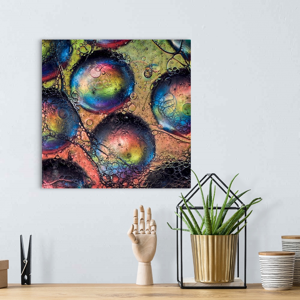 A bohemian room featuring An abstract fine art photo of several bubbles with rainbow colors.