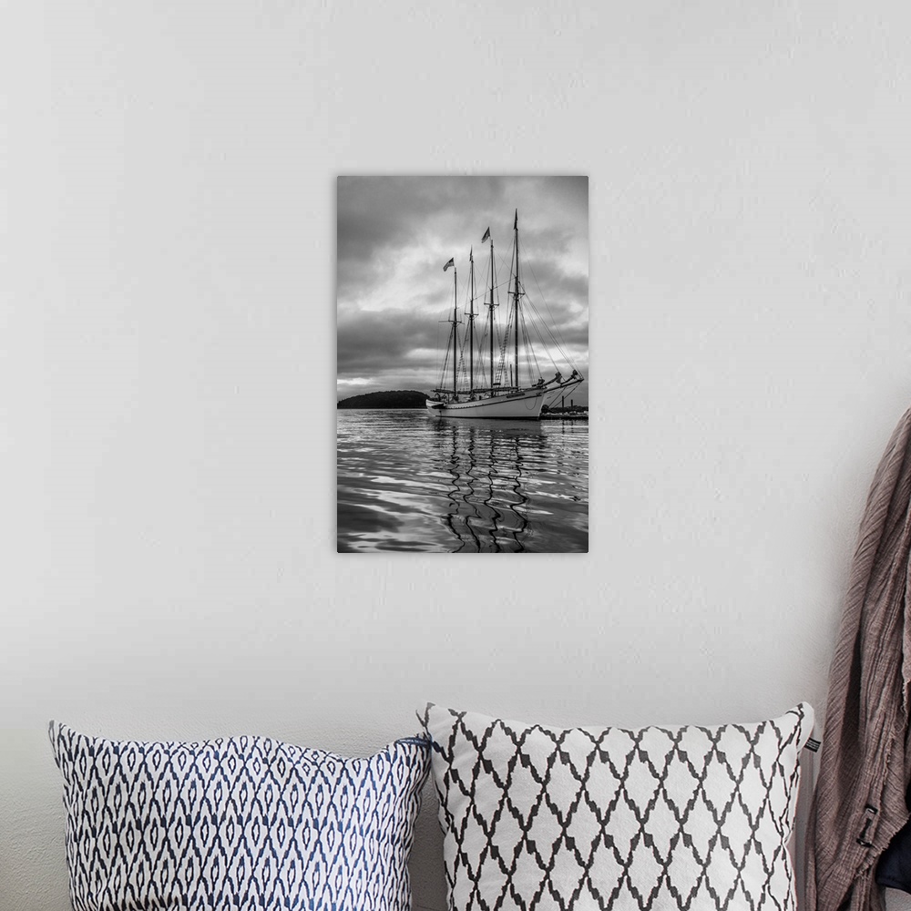 A bohemian room featuring Tall sailing ship on the water under grey skies.