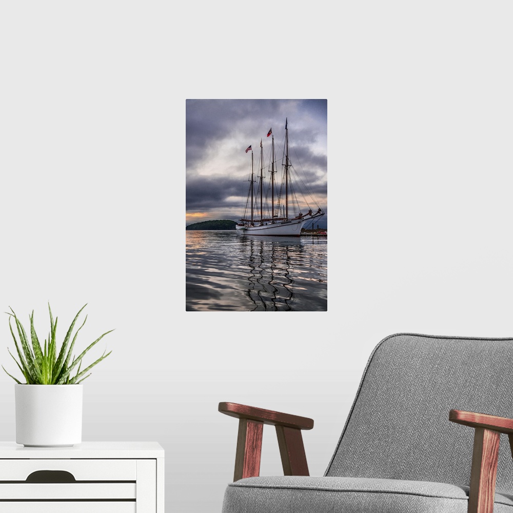 A modern room featuring Beautiful sailing ship Margaret Todd rests at it's pier amidst a dramatic atmospheric sunrise in ...