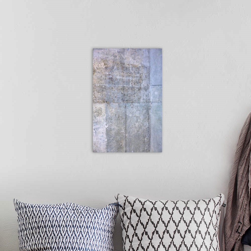 A bohemian room featuring Abstract artwork of cool colors with distressed textures throughout.