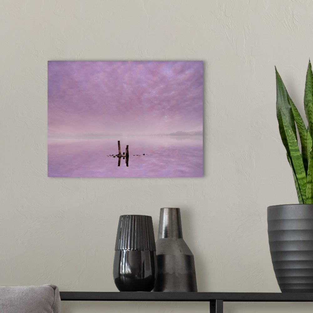 A modern room featuring Fine art photo of silhouetted posts in the lavender water of Lake Ullswater, Cumbria in the morning.