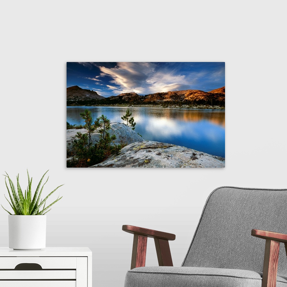 A modern room featuring Clouds and mountains reflect in the surface of the still water in this oversized art for the deco...