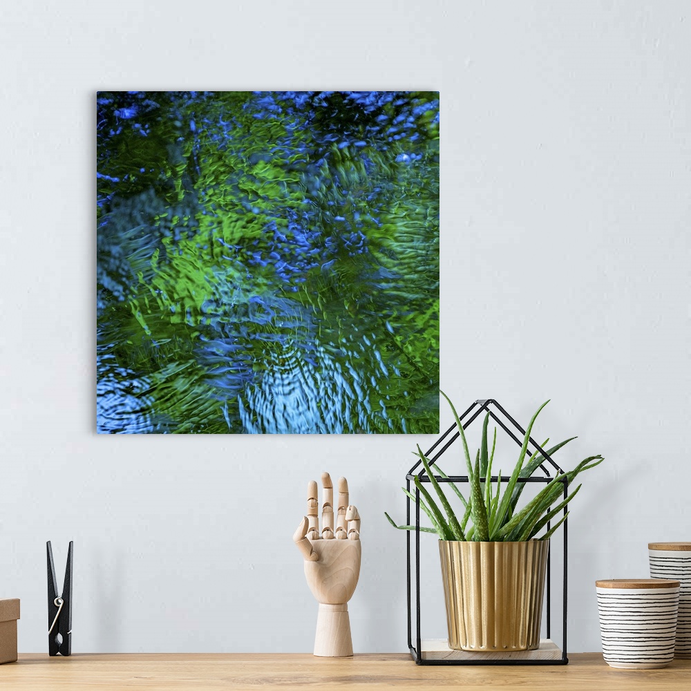 A bohemian room featuring Blue and green light reflecting in rippling water.