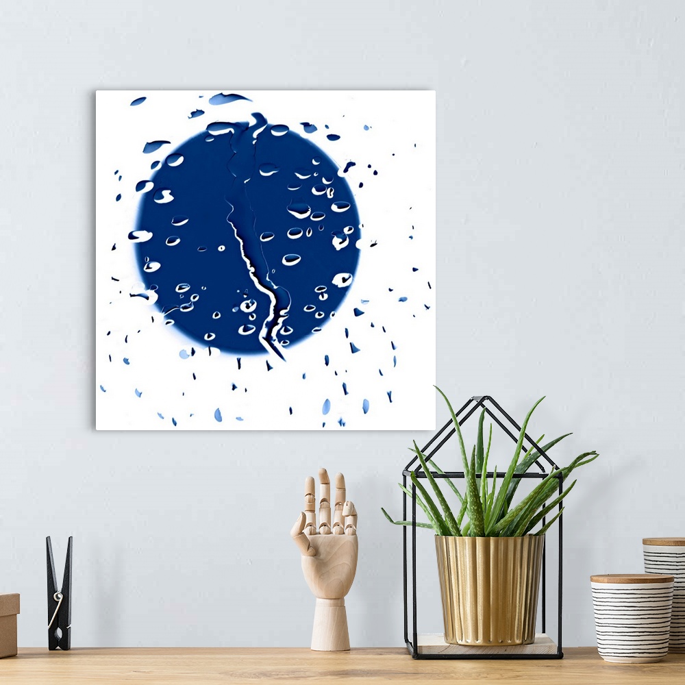 A bohemian room featuring Abstract artwork consisting of raindrops with an obscure blue shape behind.