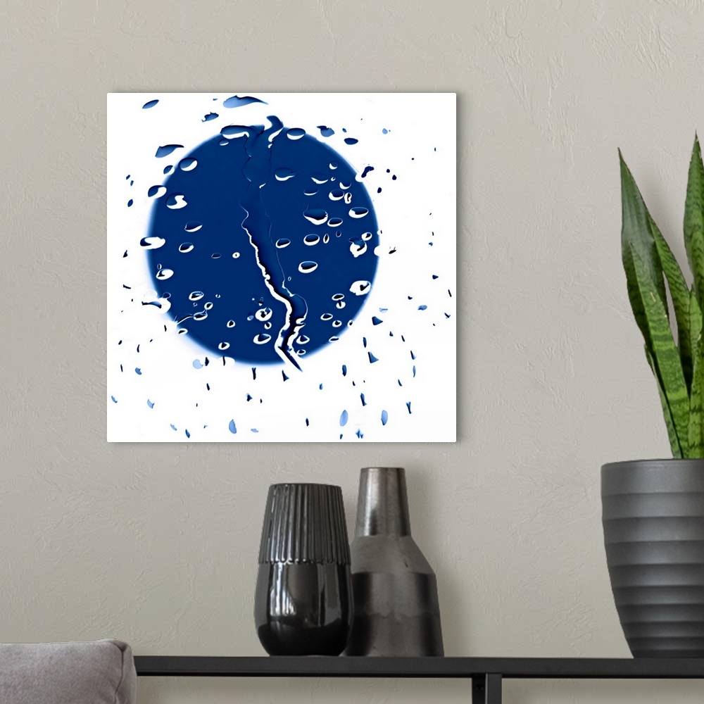 A modern room featuring Abstract artwork consisting of raindrops with an obscure blue shape behind.