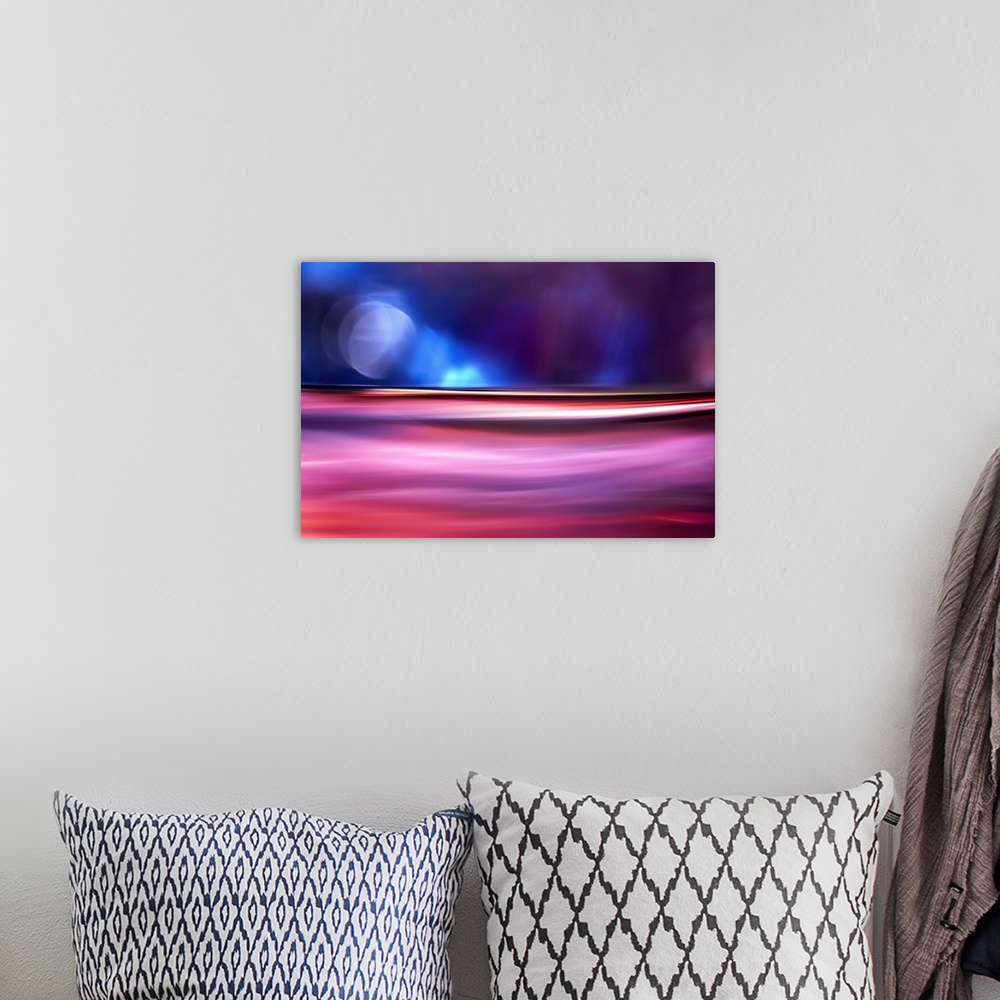 A bohemian room featuring Abstract photo of smooth waves in vivid pink tones, resembling the moon over the ocean at night.