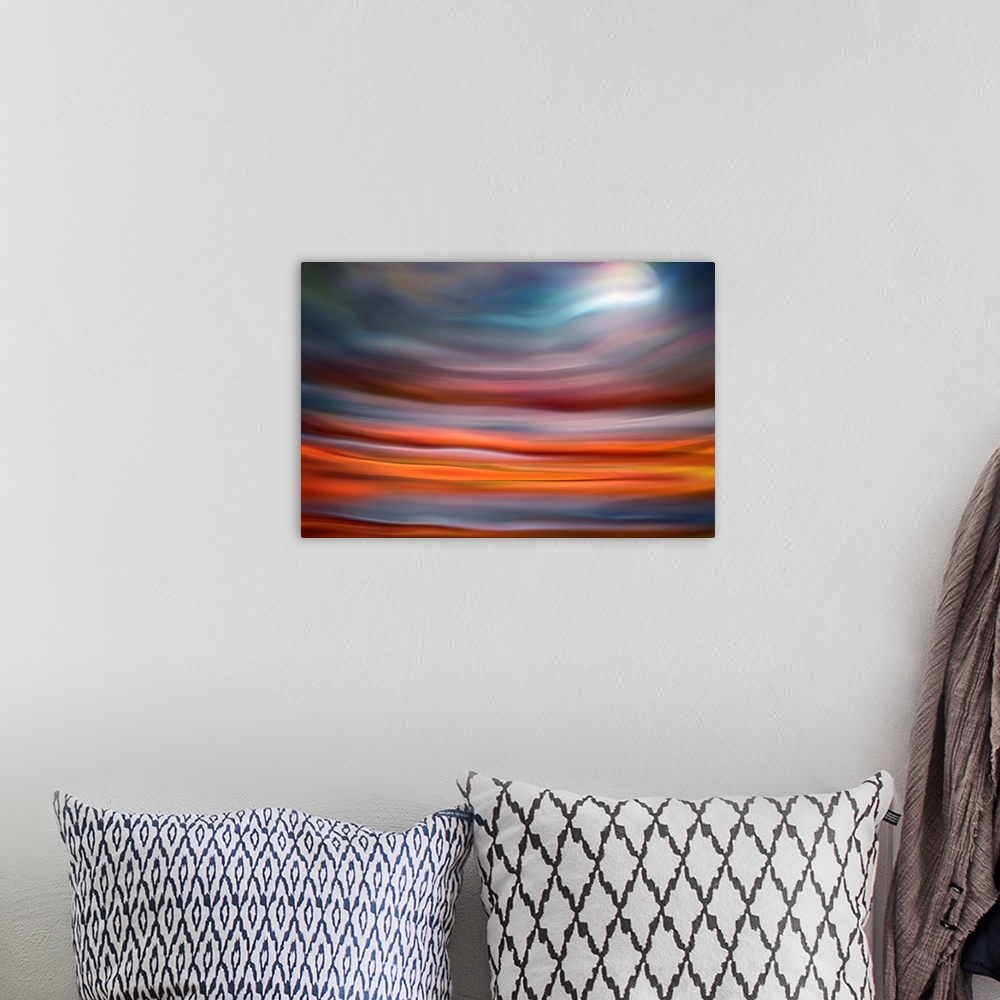 A bohemian room featuring Abstract photo of smooth waves in warm colors, resembling the moon rising over the ocean.