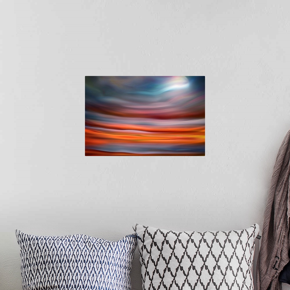 A bohemian room featuring Abstract photo of smooth waves in warm colors, resembling the moon rising over the ocean.