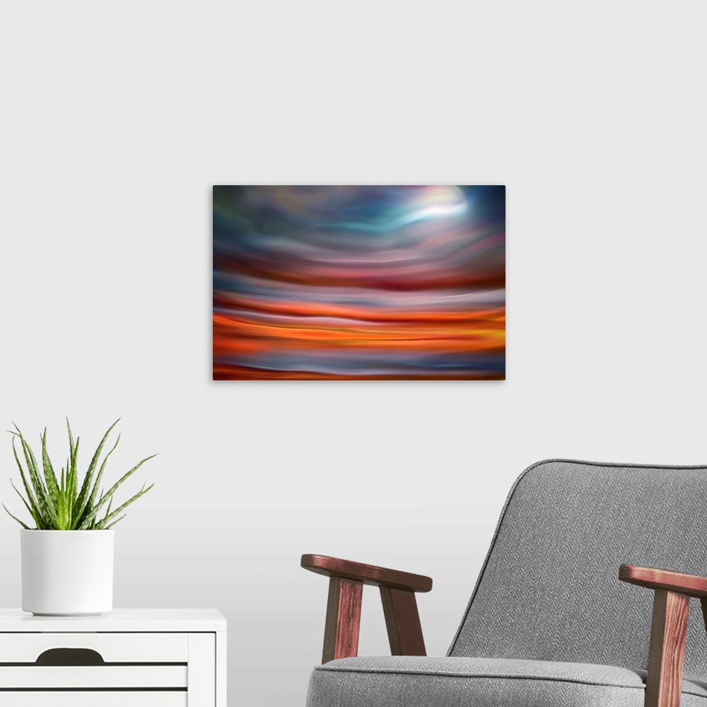 A modern room featuring Abstract photo of smooth waves in warm colors, resembling the moon rising over the ocean.