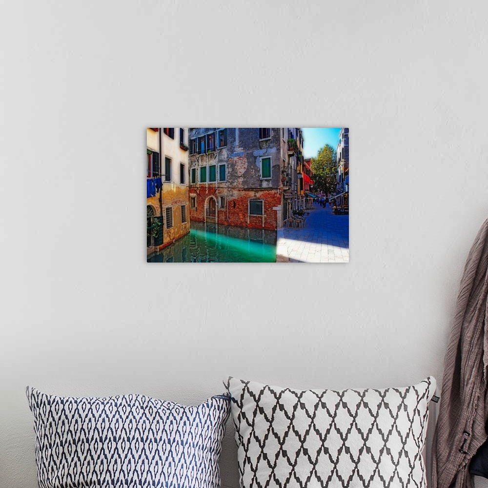 A bohemian room featuring Giant, landscape photograph of tall buildings at the edge of a canal in Calle Del Spezier, Venice...
