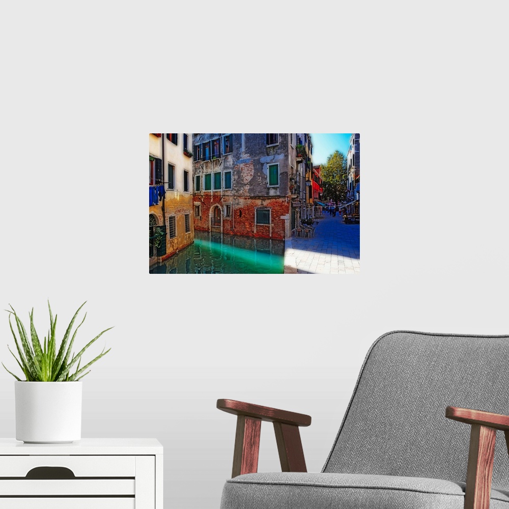 A modern room featuring Giant, landscape photograph of tall buildings at the edge of a canal in Calle Del Spezier, Venice...