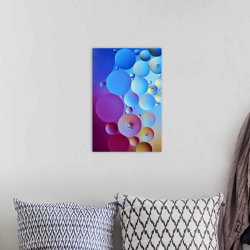 A bohemian room featuring Circular water drop stacked together with different sizes in shades of blue, pink, purple, and ye...