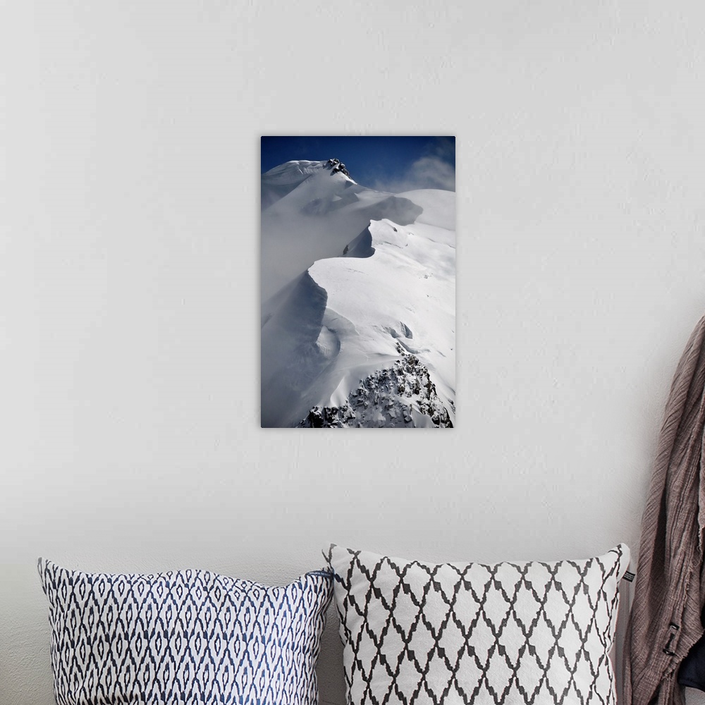 A bohemian room featuring Mont Blanc du Tacul mountain of the French Alps in France with snow, sun and wind, vertical view.