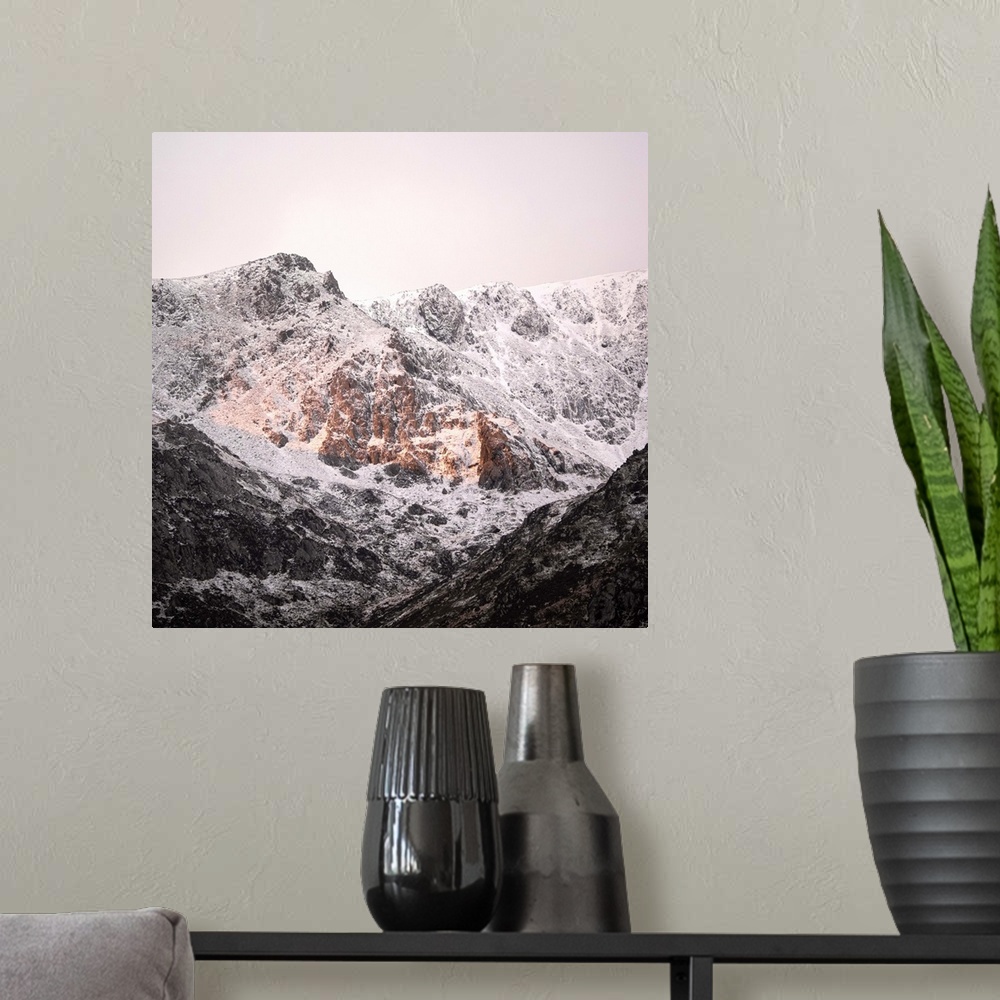 A modern room featuring A photograph of a mountain peak covered in snow.