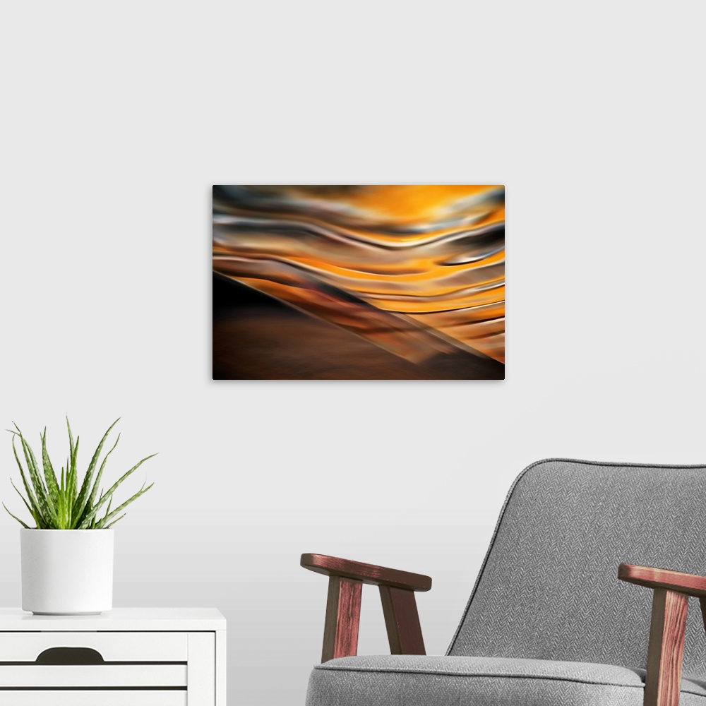 A modern room featuring Abstract artwork of flowing earthy colors that have been blended to create subtle ripples above a...
