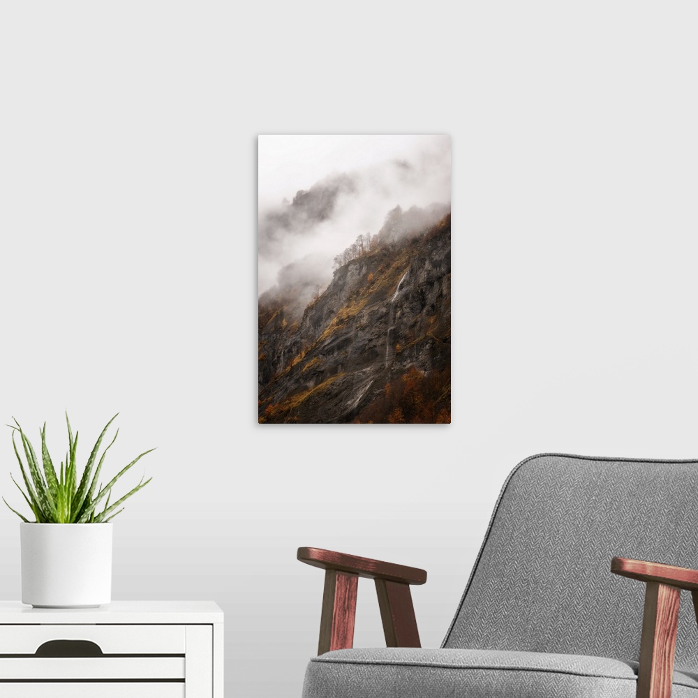 A modern room featuring Vertical view of a moutain in Sixt-Fer-a-Cheval area in the French Alps, some fog and a little wa...