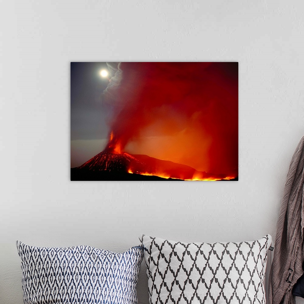 A bohemian room featuring Fine art photo of a volcano erupting and spewing ash into the night sky.