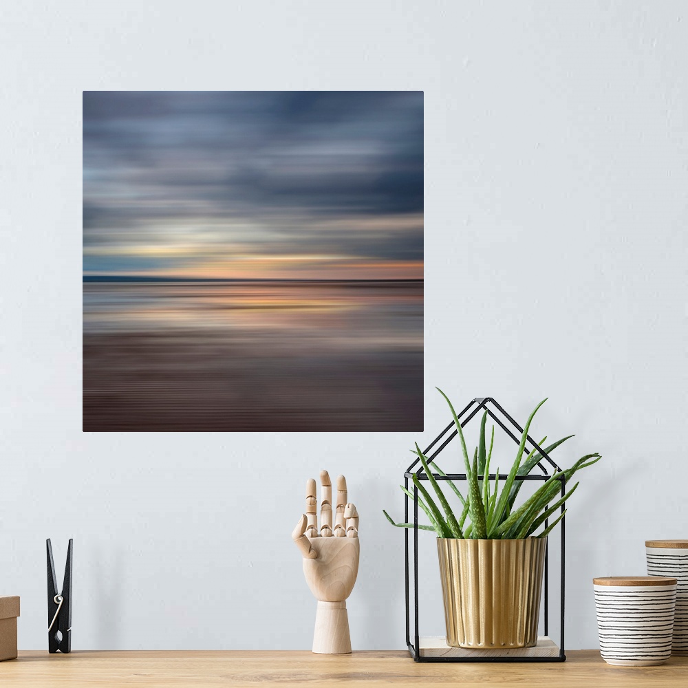 A bohemian room featuring Oversized fine art photograph of sunset on a horizon in horizontal streaks of warm and cool tones.
