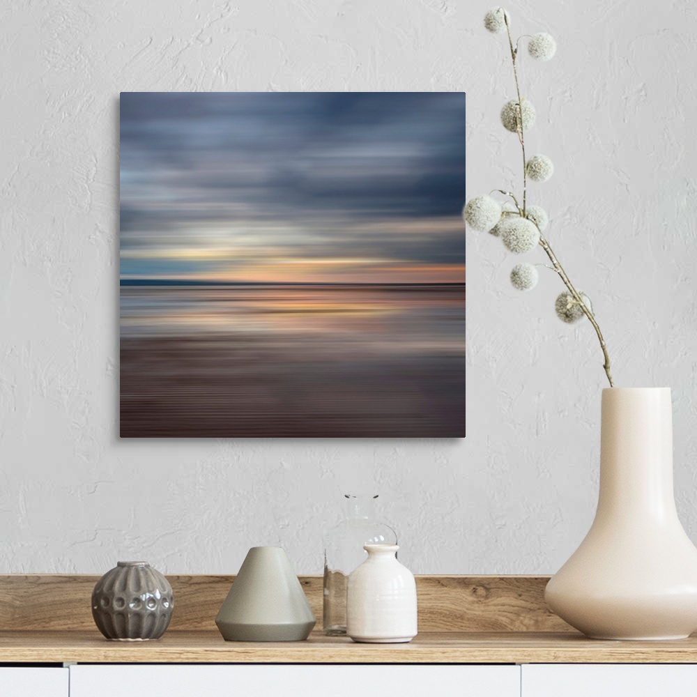 A farmhouse room featuring Oversized fine art photograph of sunset on a horizon in horizontal streaks of warm and cool tones.
