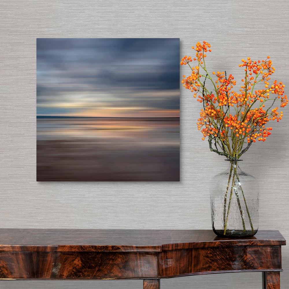 A traditional room featuring Oversized fine art photograph of sunset on a horizon in horizontal streaks of warm and cool tones.