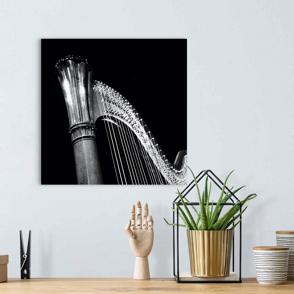 A bohemian room featuring A play of light and dark on this beautiful harp, music in the spotlight.