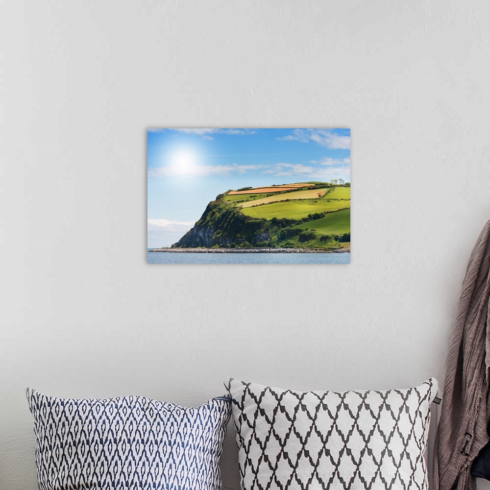 A bohemian room featuring A photograph of a coastal landscape.