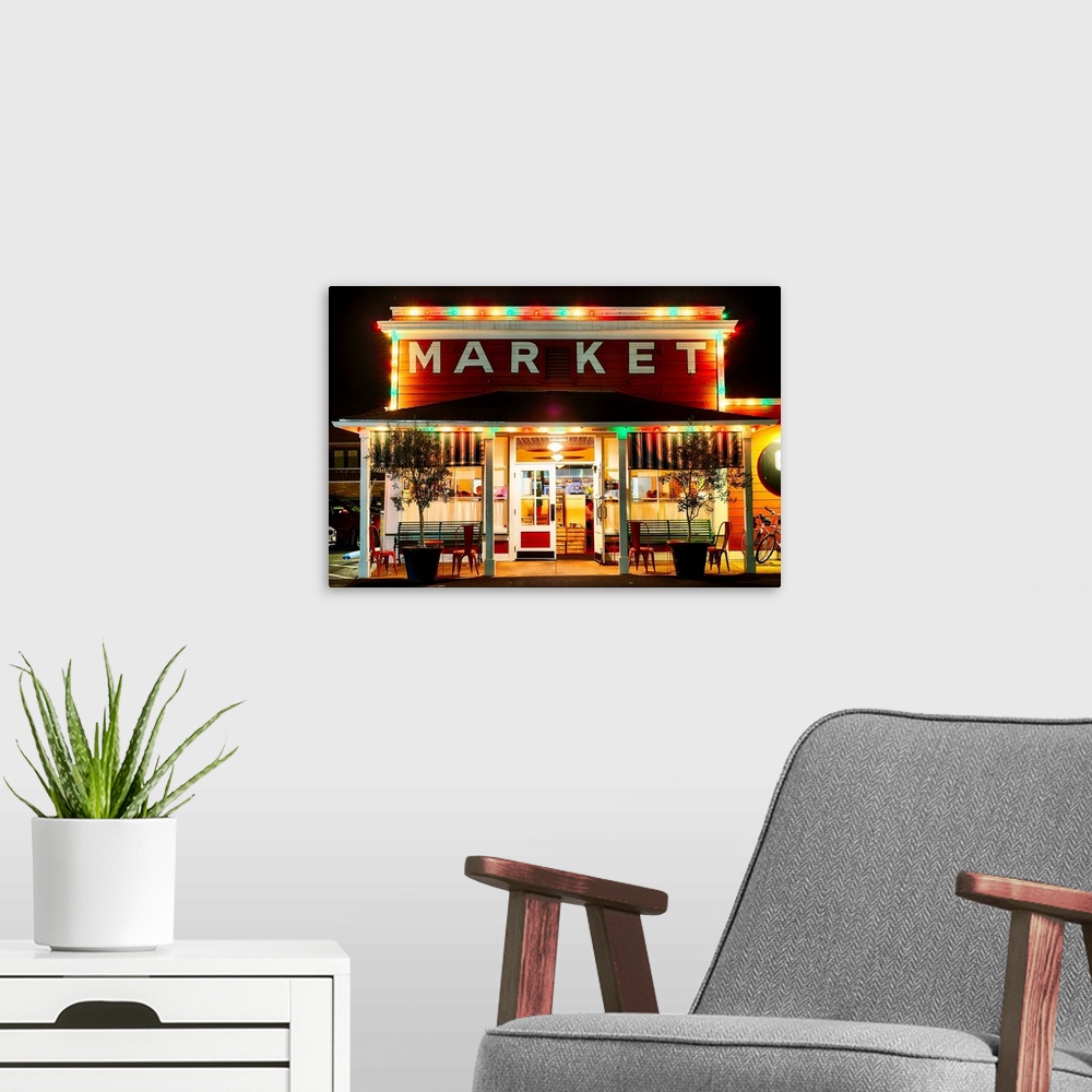 A modern room featuring Fine art photo of a market building in Napa Valley lit up at night.