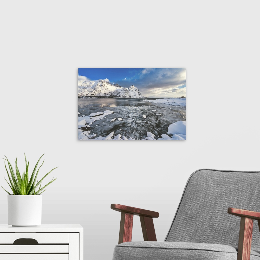 A modern room featuring A fjord surrounded by snow-capped mountains